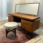 Load image into Gallery viewer, Wooden vanity desk with mirror and stool on a patterned rug
