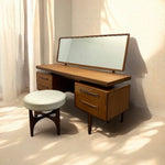 Load image into Gallery viewer, Wooden vanity table with mirror and stool in a softly lit room
