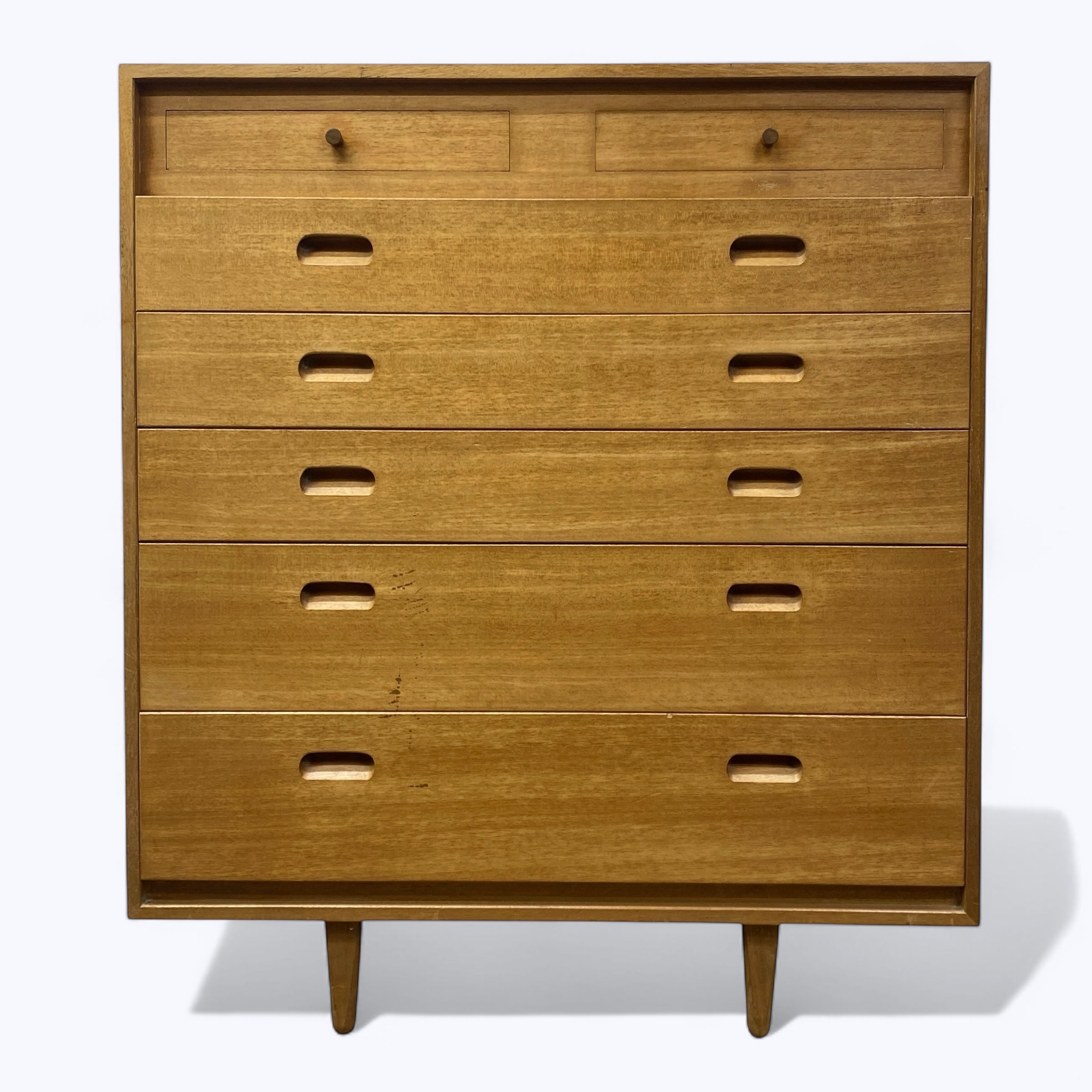 Wooden dresser with seven drawers on a white background