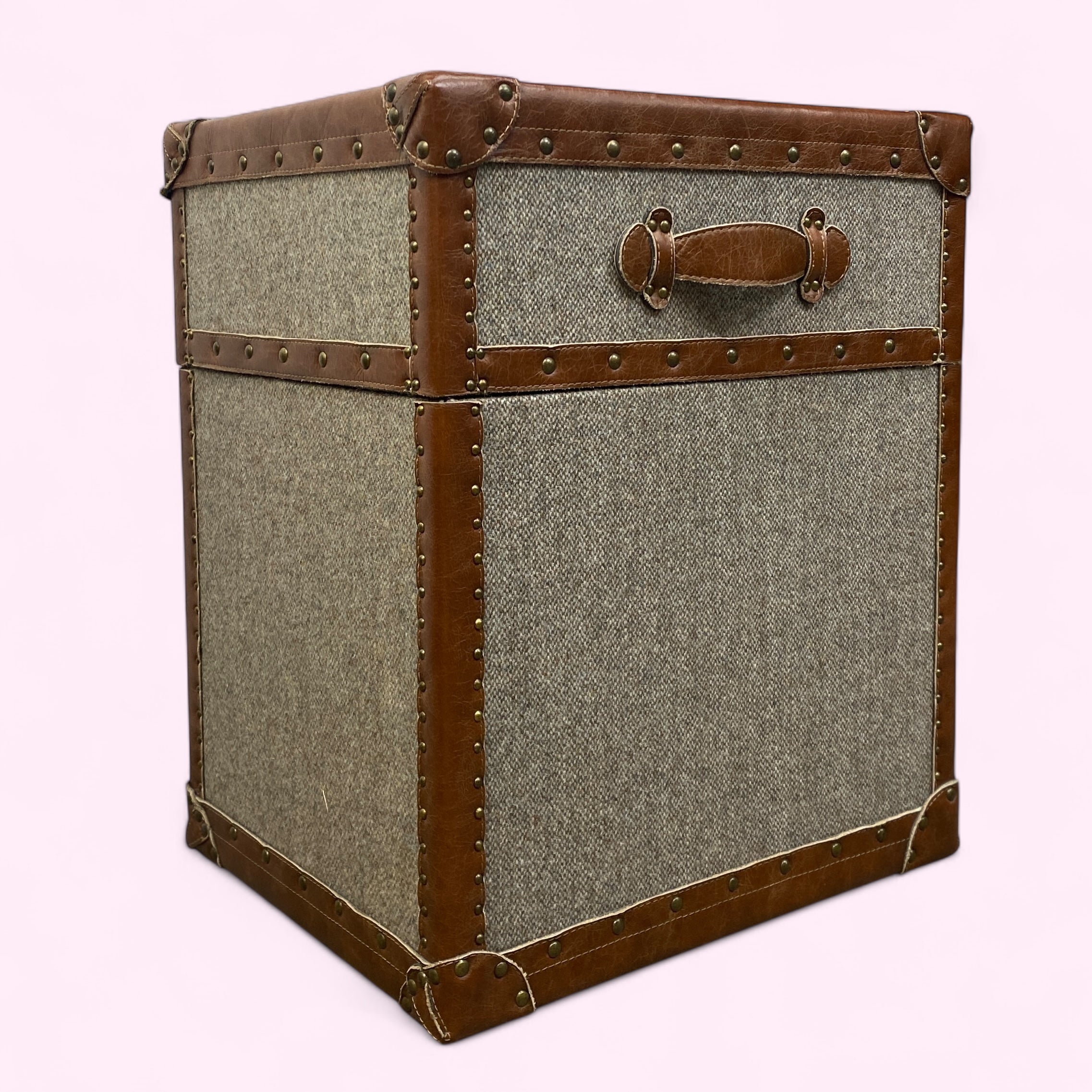 Vintage-style trunk with brown leather accents on a white background