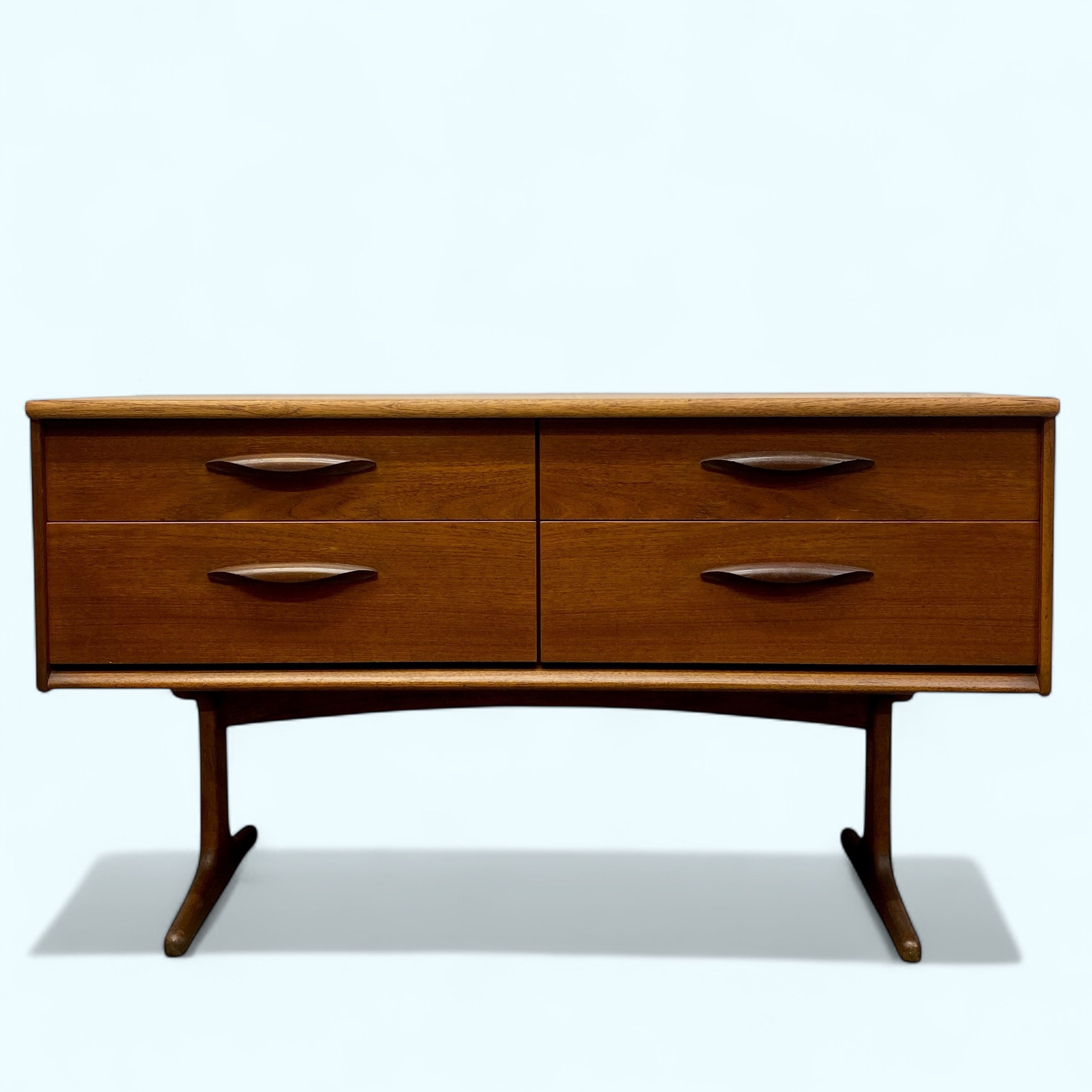 Wooden dresser with four drawers on a white background