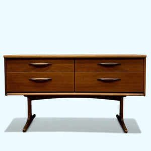 Wooden dresser with four drawers on a white background