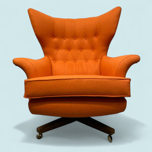 Orange armchair with tufted backrest on a light blue background