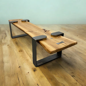Wooden bench with black metal legs on a wooden floor