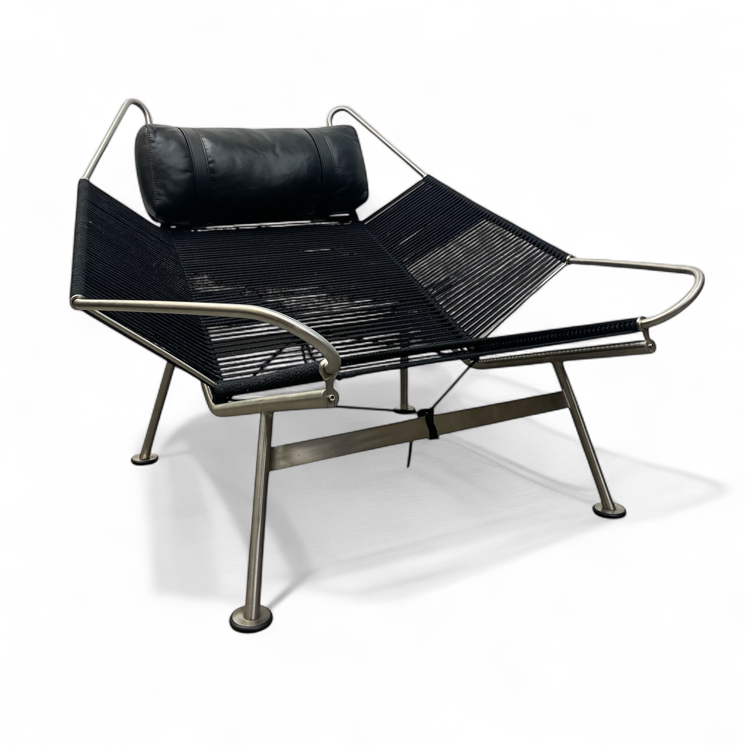 Modern black lounge chair with metal frame on a white background