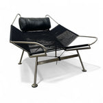 Load image into Gallery viewer, Modern black lounge chair with metal frame on a white background

