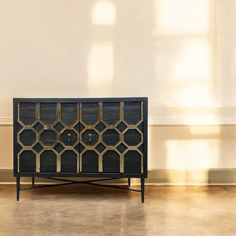 Decorative black cabinet with geometric pattern in a room with beige walls and wooden floor.