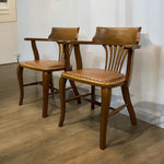 Load image into Gallery viewer, Two wooden chairs  on a wooden floor.
