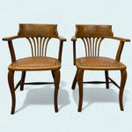 Load image into Gallery viewer, Two wooden chairs with leather seats on a light blue background
