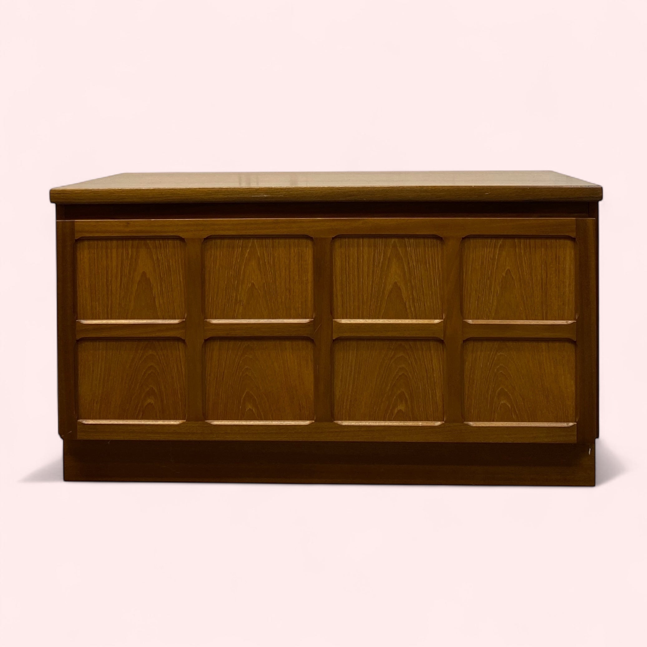 Wooden chest with a light brown finish on a white background