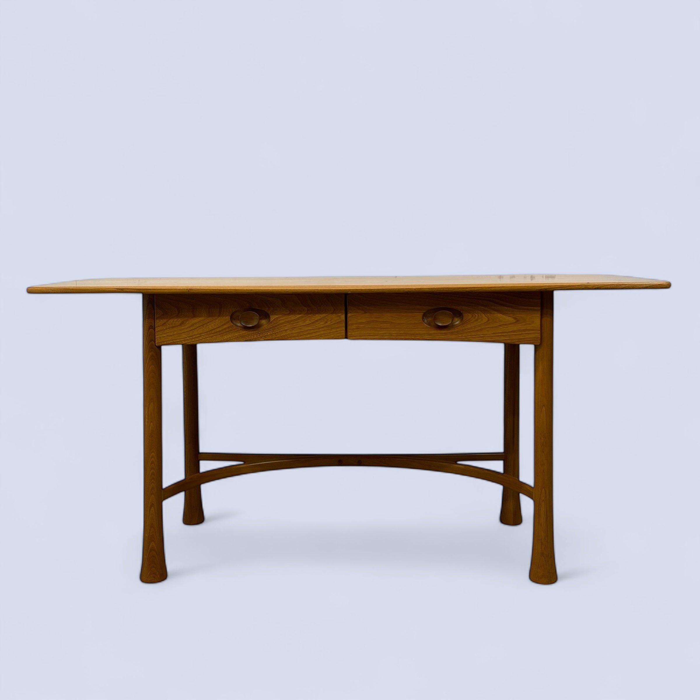 Wooden desk with two drawers on a light blue background