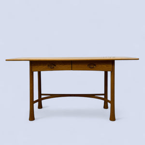 Wooden desk with two drawers on a light blue background