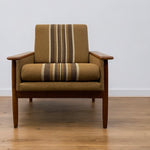 Load image into Gallery viewer, Brown armchair with striped pattern on a wooden floor and white wall background
