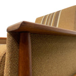 Load image into Gallery viewer, Close-up of a brown upholstered chair with wooden armrests on a white background
