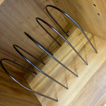 Load image into Gallery viewer, Black metal shelf brackets on a wooden surface
