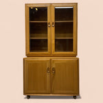Load image into Gallery viewer, Wooden cabinet with glass doors on a beige background
