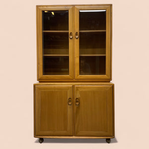 Wooden cabinet with glass doors on a beige background