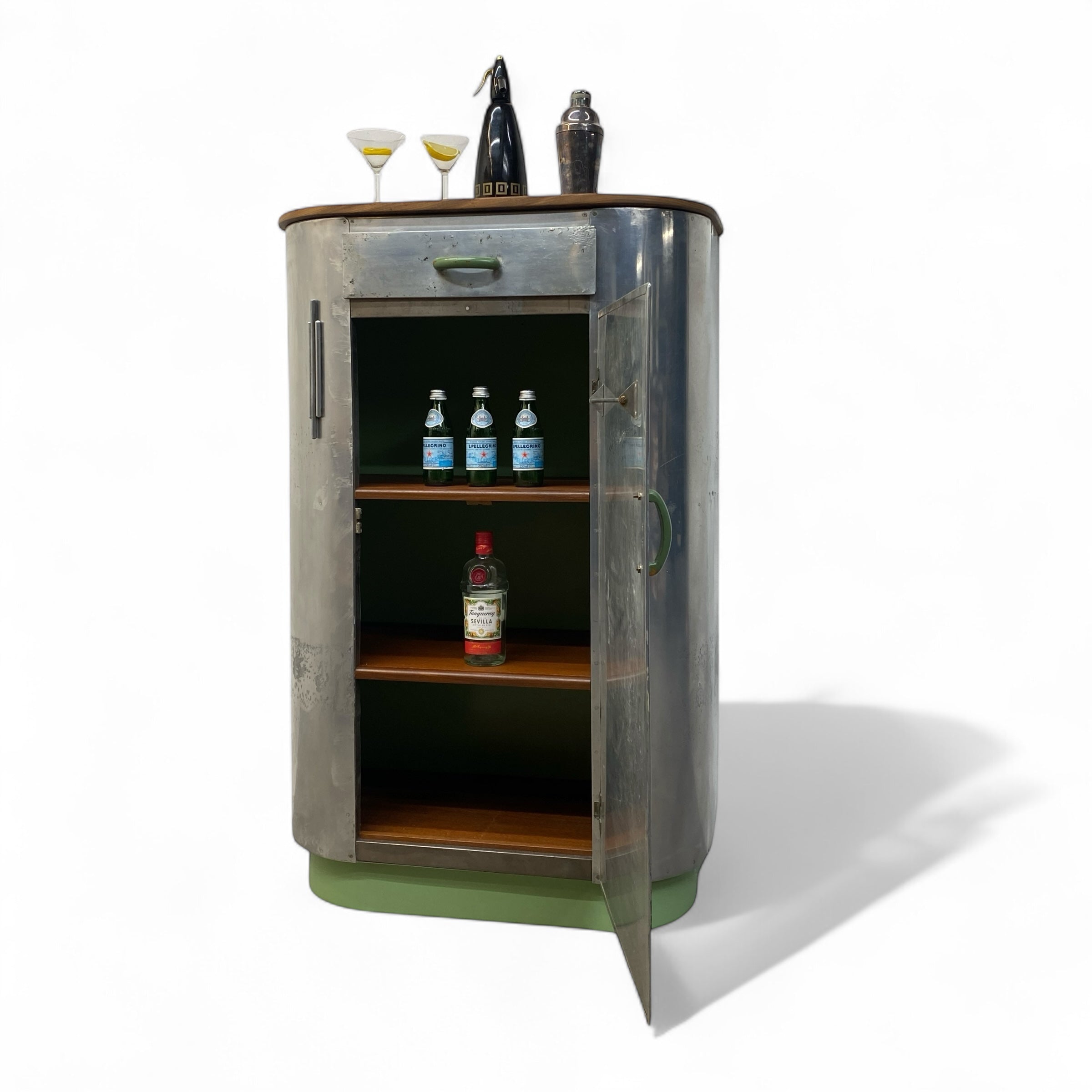 Bar cabinet with open door displaying bottles and glasses on a white background