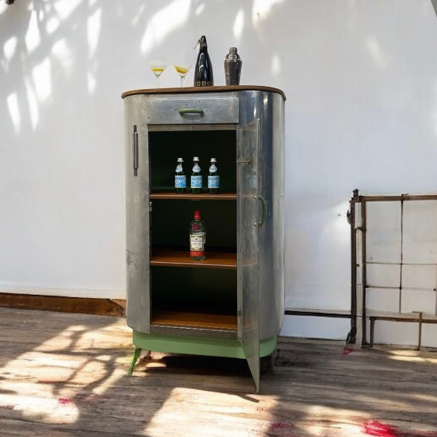 Vintage-style bar cabinet with drinks on a wooden floor.