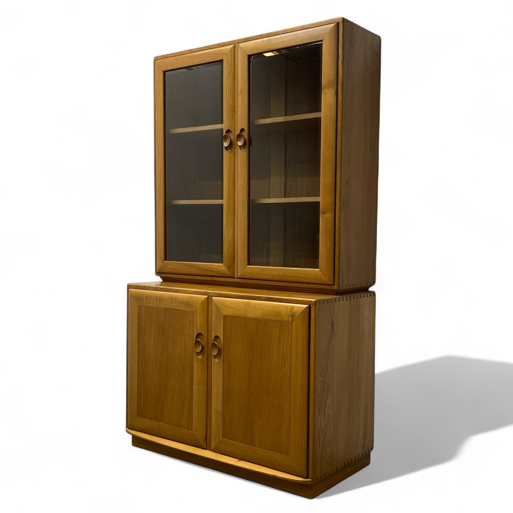 Wooden cabinet with glass doors on a white background