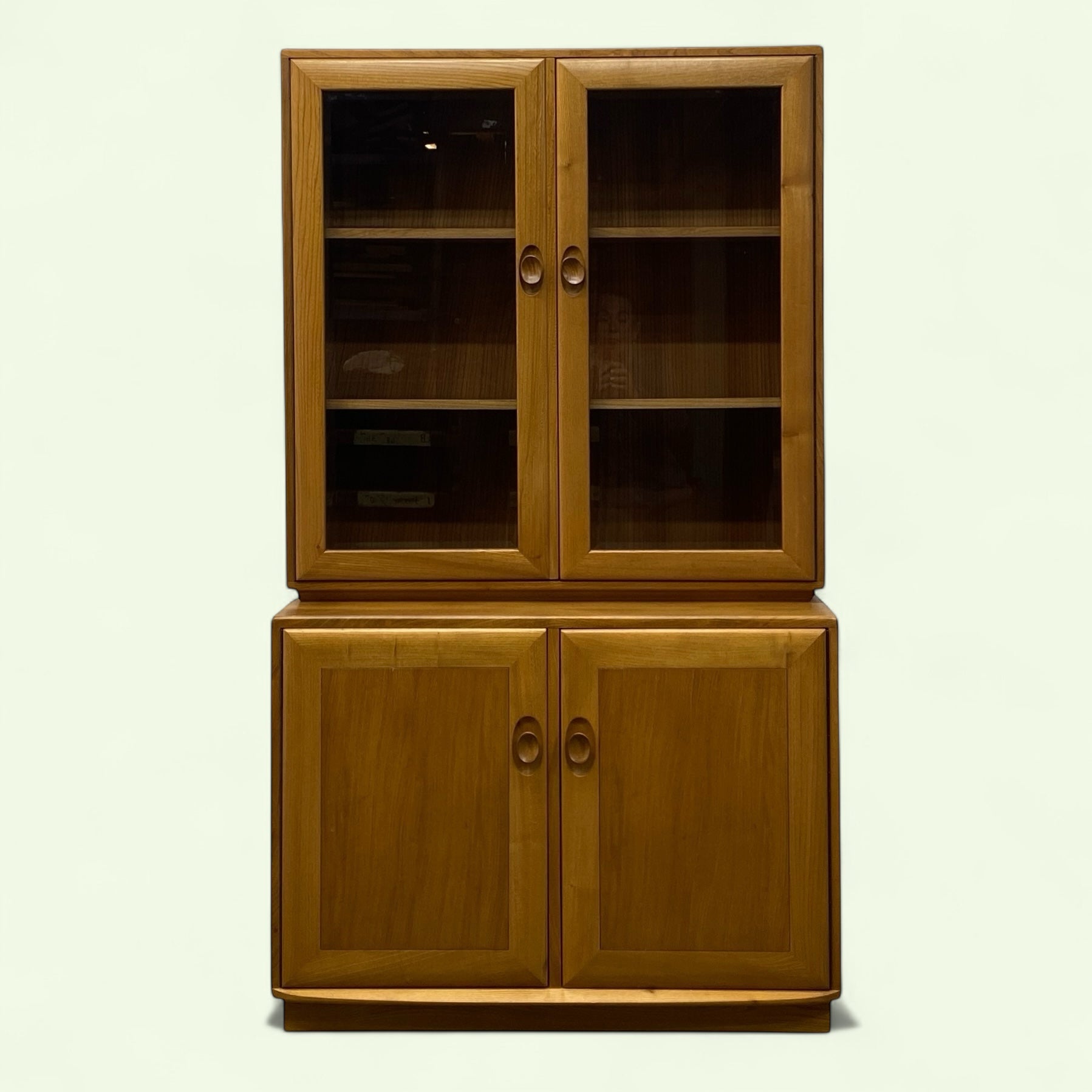 Wooden cabinet with glass doors on a white background