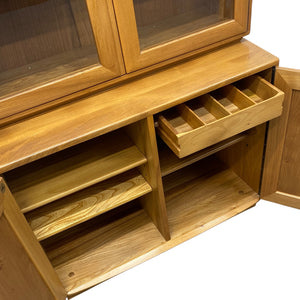 Wooden cabinet with shelves and drawers on a white background