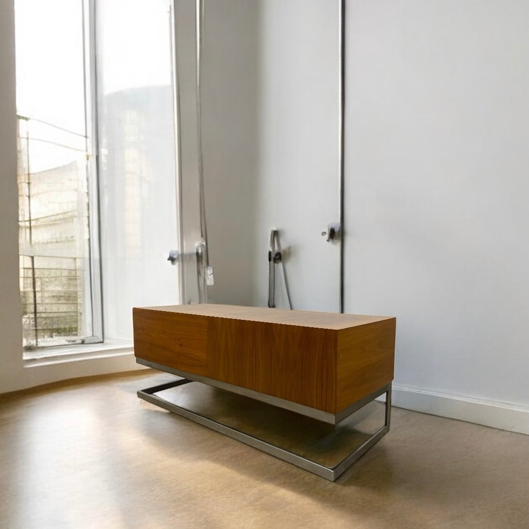 Wooden cabinet with metal legs in a room with large windows