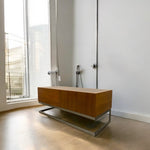 Load image into Gallery viewer, Wooden cabinet with metal legs in a room with large windows
