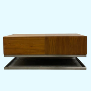 Wooden coffee table with a reflective base on a white background