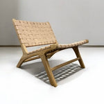 Load image into Gallery viewer, Wooden chair with woven backrest on a white floor and gray wall background
