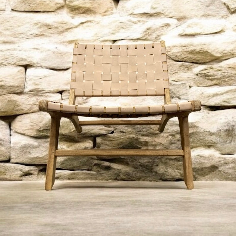 Woven chair against a stone wall