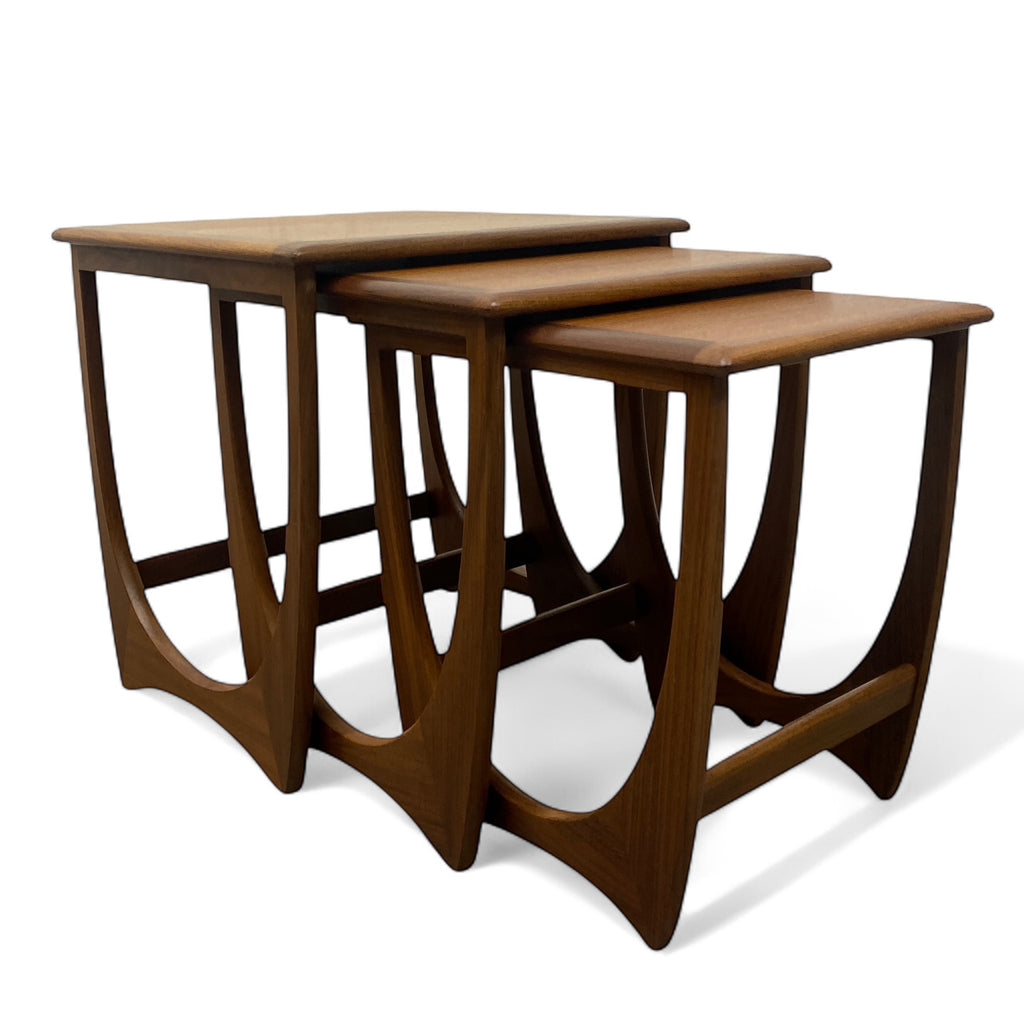 Set of three wooden nesting tables on a white background