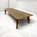 Load image into Gallery viewer, Wooden coffee table on a marble floor with white walls
