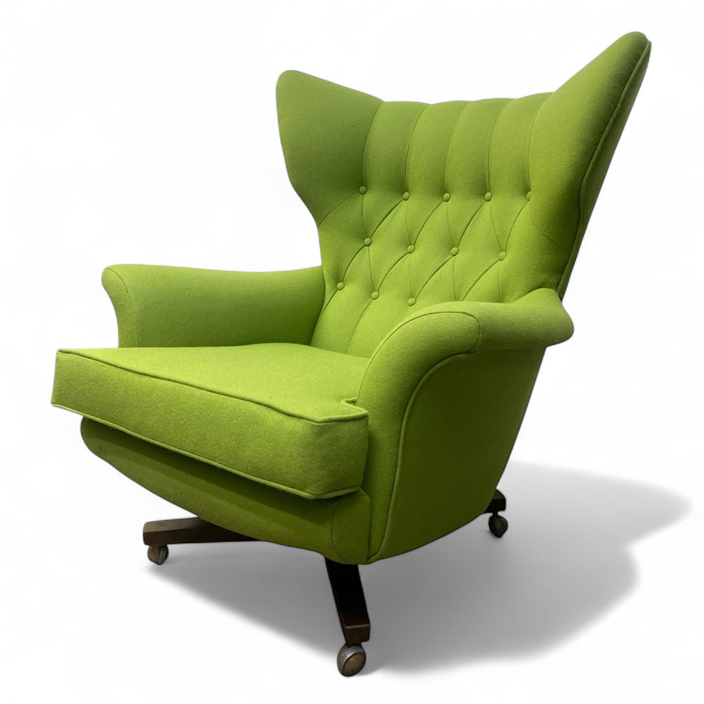 Green armchair with tufted backrest on a white background