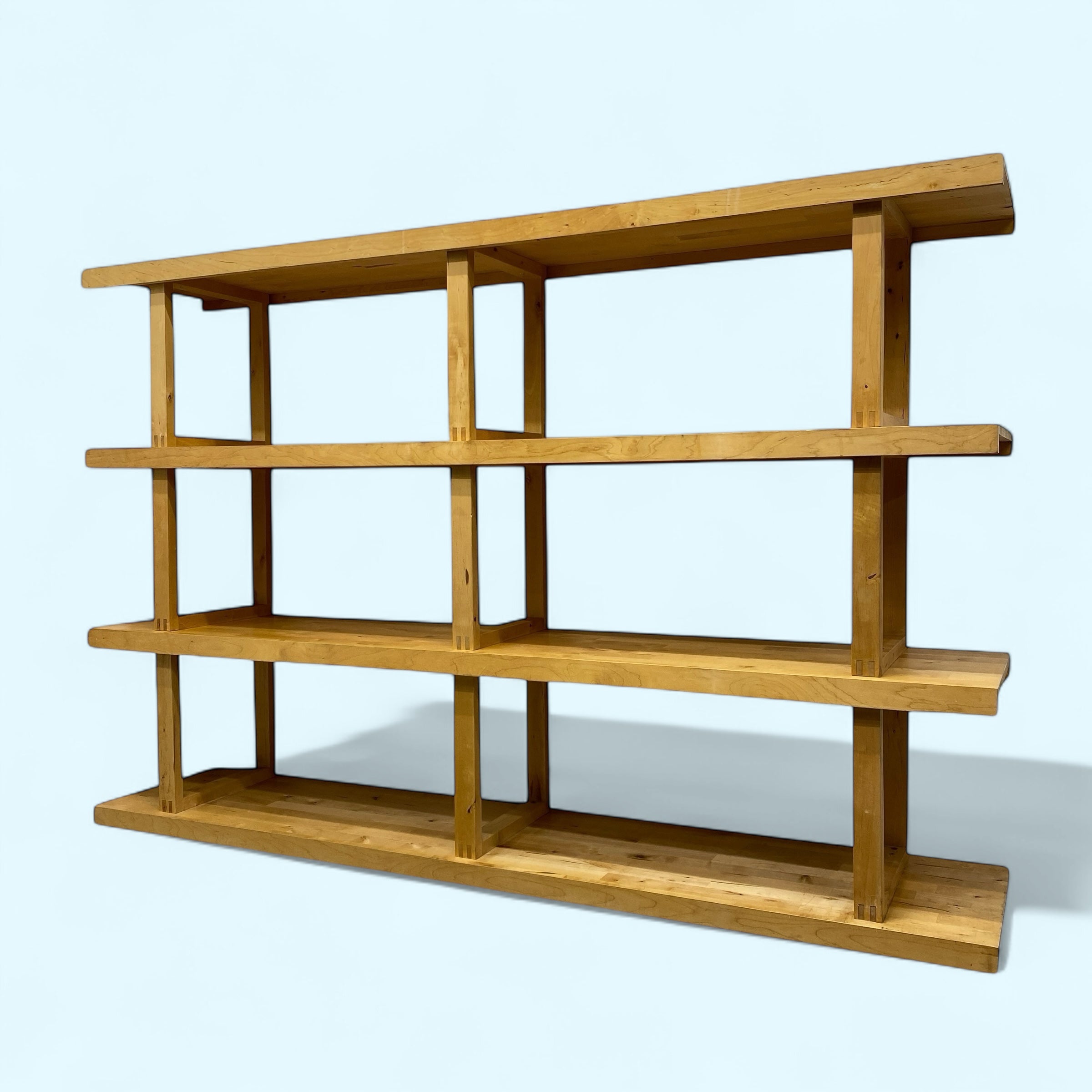 Wooden shelf with four shelves on a light blue background