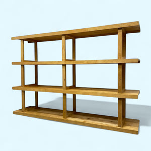 Wooden shelf with four shelves on a light blue background