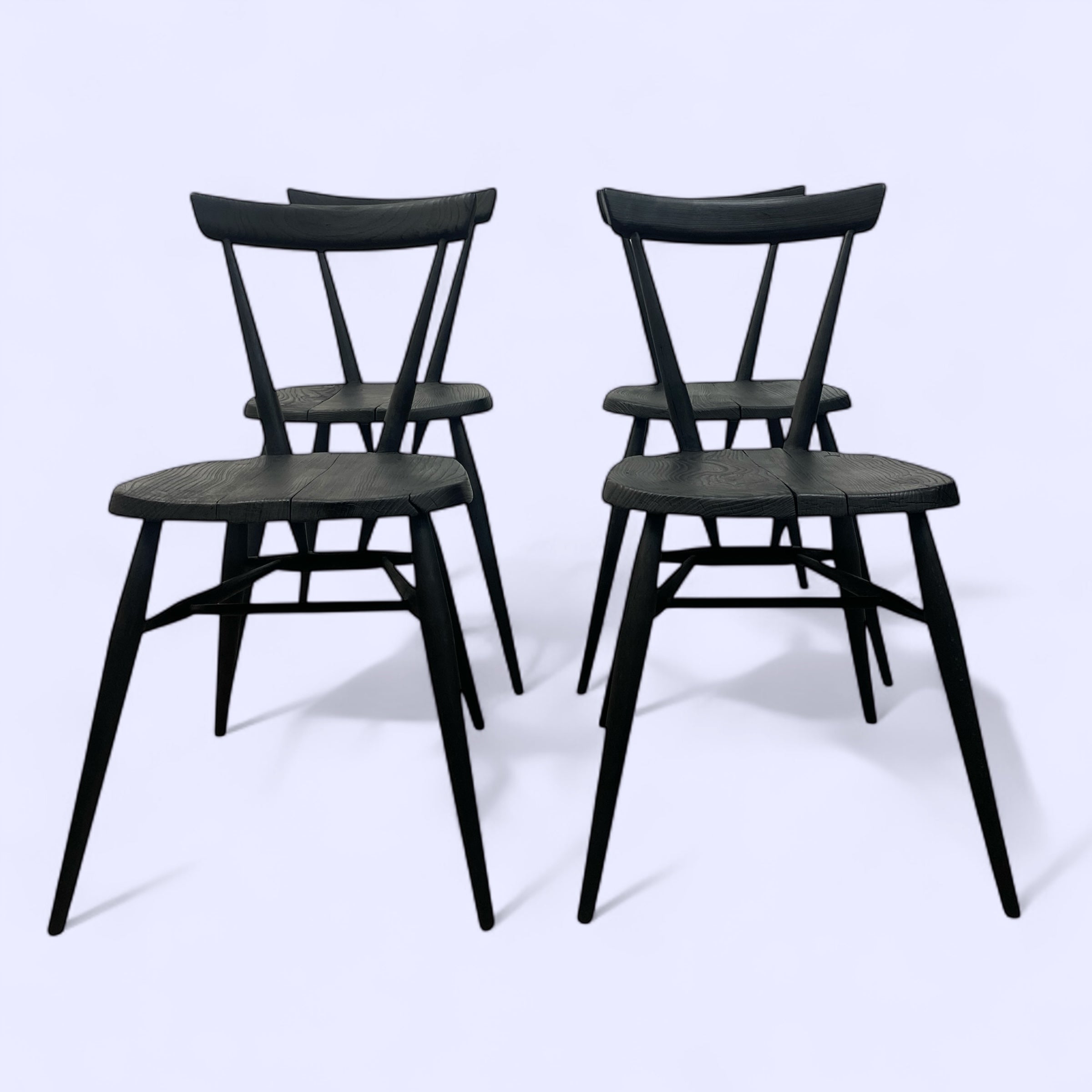 Four black chairs on a white background