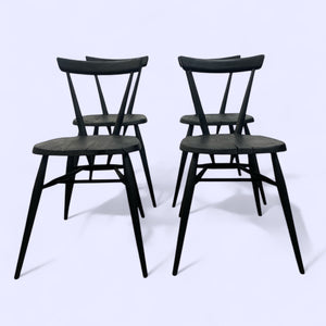 Four black chairs on a white background