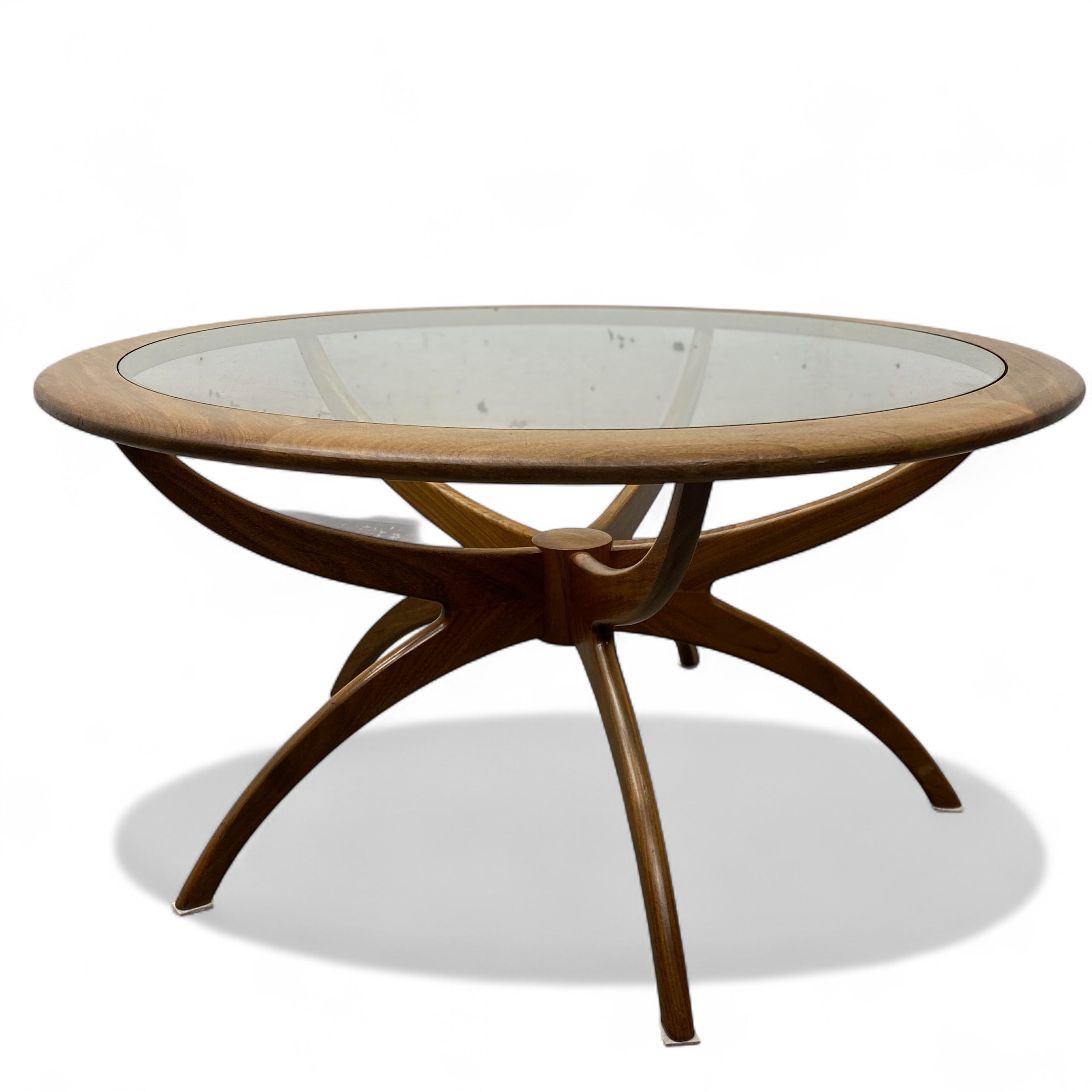 Round wooden table with glass top on a white background