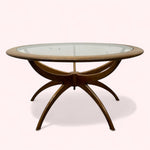 Load image into Gallery viewer, Round glass-top table with wooden base on a white background
