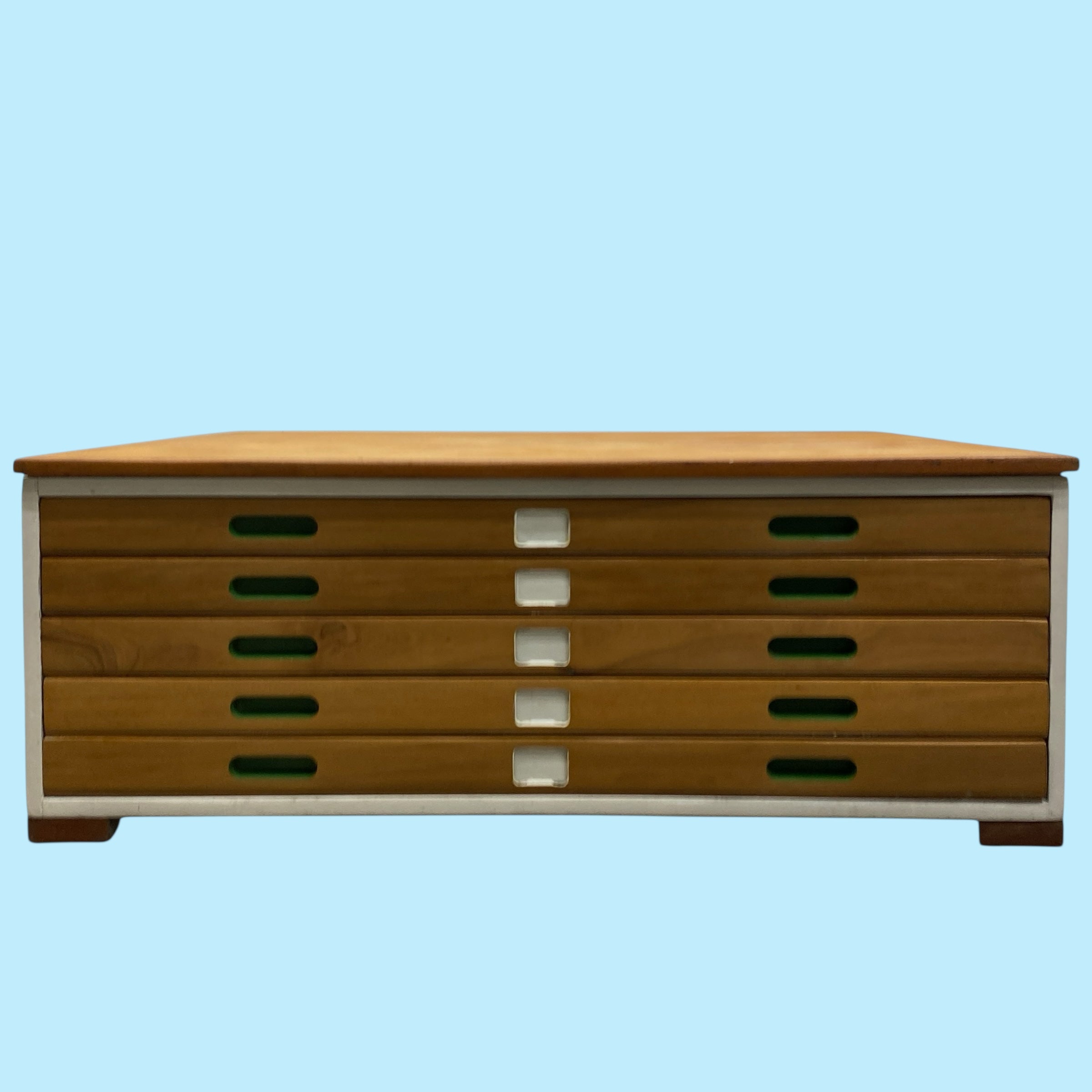 Wooden drawer unit with a light blue background