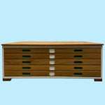 Load image into Gallery viewer, Wooden drawer unit with a light blue background
