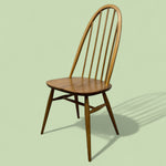 Load image into Gallery viewer, Wooden chair on a light green background
