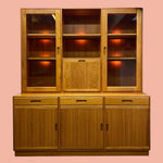 Load image into Gallery viewer, Wooden cabinet with glass doors on a pink background
