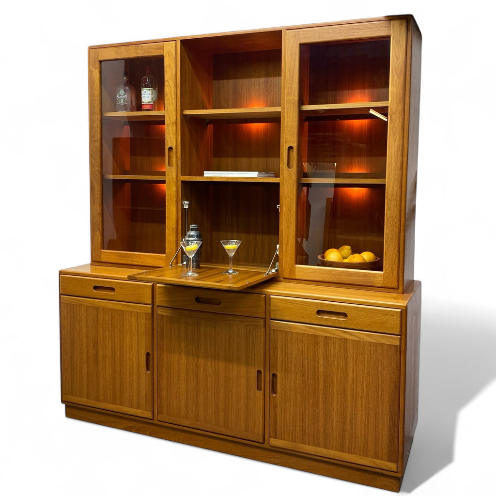 Wooden cabinet with glass doors displaying items on a white background