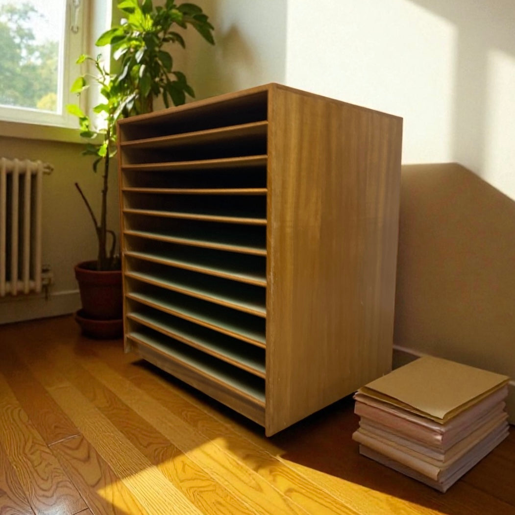 Wooden PLAN CHEST with books and a plant in a room with natural light