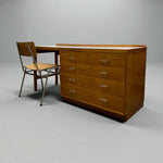 Load image into Gallery viewer, Wooden desk with multiple drawers and a chair on a gray background
