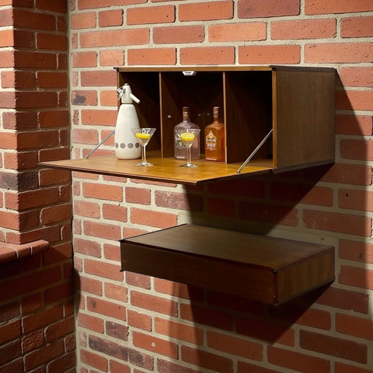 Wall-mounted bar cabinet with drinks against a brick wall