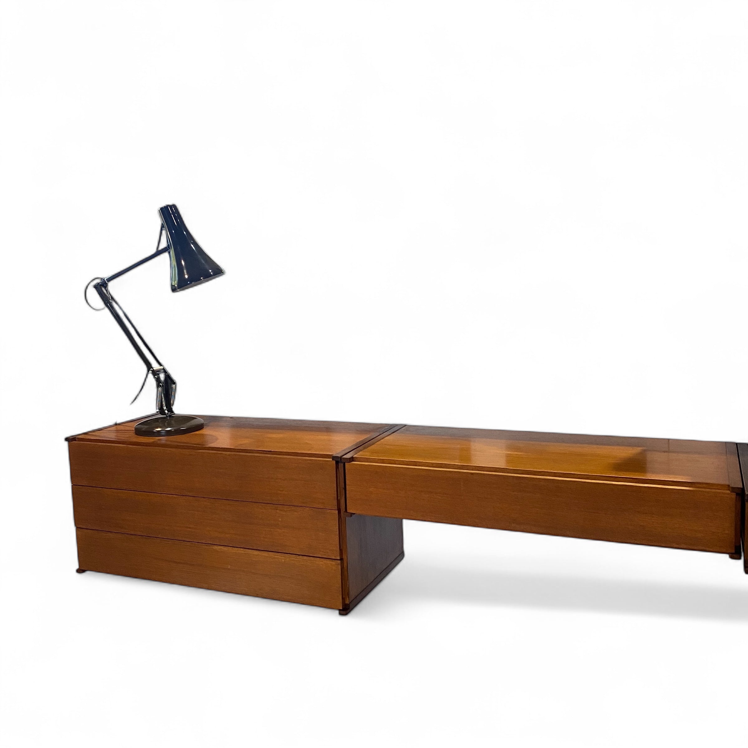 three drawers and a desk with lamp