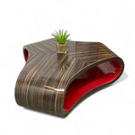 Load image into Gallery viewer, Modern coffee table with wavy design and red interior on a white background
